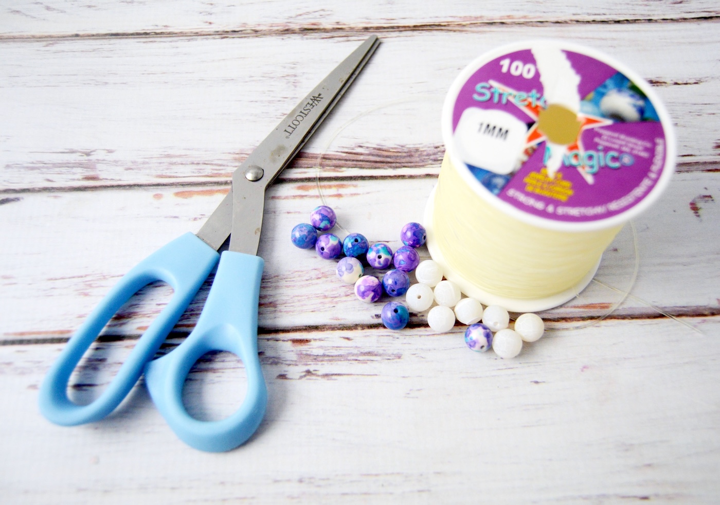 scissors, glass beads, and elastic cord