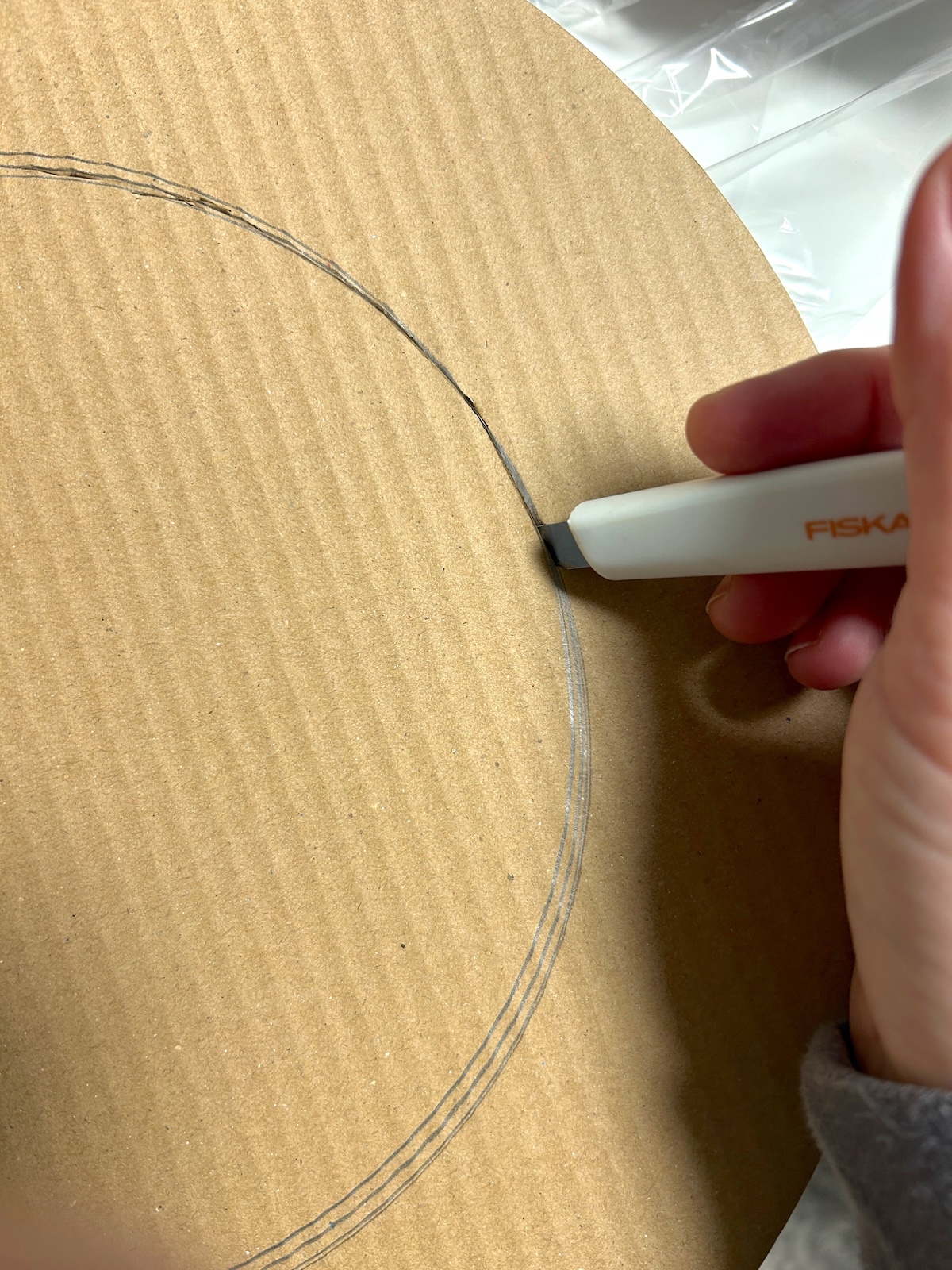 cutting the cardboard ring with a craft knife