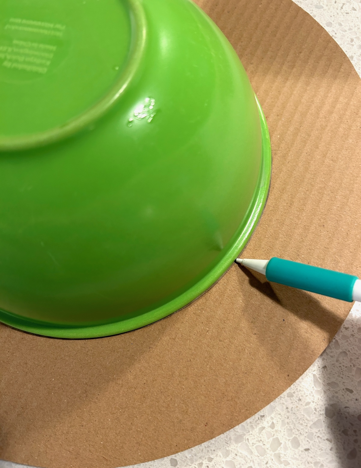 tracing a bowl onto a piece of cardboard